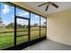 Enclosed lanai with a ceiling fan overlooking the lush yard and canal at 2625 Albion Ave, Orlando, FL 32833