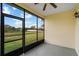 Enclosed lanai with ceiling fan overlooks the green yard and waterway at 2625 Albion Ave, Orlando, FL 32833