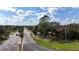 A street view reveals a neighborhood entrance with landscaped signage and a tree-lined street at 2625 Albion Ave, Orlando, FL 32833