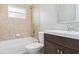 Updated bathroom with tiled shower-tub combo, dark wood vanity, and bright, clean finishes at 2934 Truman Blvd, Sanford, FL 32771