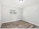 An empty bedroom with wood-look flooring and natural light at 2934 Truman Blvd, Sanford, FL 32771