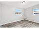 An empty bedroom with wood-look flooring and natural light at 2943 Truman Blvd, Sanford, FL 32771