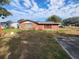 View of backyard with grass, trees and clear sky at 3430 Kathy Ct, Lakeland, FL 33810