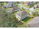 An aerial view of a home's backyard and roof, surrounded by neighboring houses and lush trees at 3819 Breckinridge Ln, Clermont, FL 34711