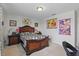 Cozy bedroom with a well-lit nightstand next to a decorative bed and a large picture on the wall at 3819 Breckinridge Ln, Clermont, FL 34711