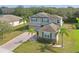 Stunning two-story home featuring a brick driveway, lush landscaping, and a neutral color palette at 3819 Breckinridge Ln, Clermont, FL 34711