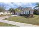 Two-story home showcasing a paver driveway, lush green lawn, and an inviting facade at 3819 Breckinridge Ln, Clermont, FL 34711