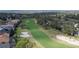 Scenic aerial view of the golf course, showcasing the lush green fairways and sand traps at 3819 Breckinridge Ln, Clermont, FL 34711