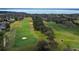 Aerial view of a scenic golf course, showcasing the beautiful greens with waterfront view at 3819 Breckinridge Ln, Clermont, FL 34711