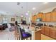 Open kitchen featuring granite countertops, breakfast bar, and seamless flow into the living room at 3819 Breckinridge Ln, Clermont, FL 34711