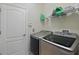 Modern laundry room with front loading washer and dryer and wire shelving for storage at 3819 Breckinridge Ln, Clermont, FL 34711