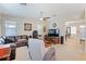 Inviting living room with a plush leather sectional, ceiling fan and neutral carpet throughout at 3819 Breckinridge Ln, Clermont, FL 34711