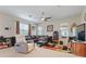 Cozy living room with a comfortable leather sectional, ceiling fan, and entertainment center at 3819 Breckinridge Ln, Clermont, FL 34711