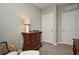 Cozy bedroom featuring a dresser with decorative lamp and chair with patterned pillow at 3987 Silverstream Ter, Sanford, FL 32771