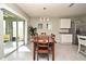 Cozy dining room featuring sliding glass doors, a modern chandelier, and stainless steel refrigerator at 3987 Silverstream Ter, Sanford, FL 32771