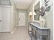 Inviting hallway featuring a decorative console table with a stylish lamp and mirror at 3987 Silverstream Ter, Sanford, FL 32771