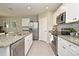 Well-equipped kitchen featuring stainless steel appliances and granite countertops with a tile backsplash at 3987 Silverstream Ter, Sanford, FL 32771