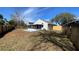 An expansive backyard featuring a white home with a screened porch and wood fence at 425 Cadenza Dr, Orlando, FL 32807