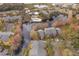 Aerial view of community featuring a lakefront pool, surrounding trees, and colorful yellow residential apartment buildings at 4536 Commander Dr # 1537, Orlando, FL 32822