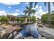 Scenic pond view featuring decorative rocks, mature palm trees, and lush landscaping at 4536 Commander Dr # 1537, Orlando, FL 32822