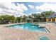 Community pool with sundeck, lush landscaping, and cabana offers a resort-like experience at 4536 Commander Dr # 1537, Orlando, FL 32822