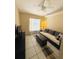 Cozy bedroom featuring a ceiling fan, a window, and a couch with pillows and ottoman at 459 Wood Rose Ln, Altamonte Springs, FL 32714