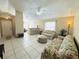 Open-concept living room with tile flooring, ceiling fan, and lots of natural light at 459 Wood Rose Ln, Altamonte Springs, FL 32714