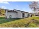 Exterior rear of a house featuring a well-kept lawn, with sliding glass doors and back entry at 4804 Laddie Ct, Orlando, FL 32821