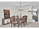 Dining area features a chandelier and seating for six, adjacent to the kitchen and living spaces at 4804 Laddie Ct, Orlando, FL 32821