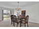 Dining area features a chandelier and seating for six, next to a sliding door and built-in shelving at 4804 Laddie Ct, Orlando, FL 32821