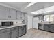 Well-lit kitchen features stainless steel appliances, gray cabinets, and modern flooring at 4804 Laddie Ct, Orlando, FL 32821