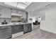 Galley kitchen featuring stainless steel appliances, gray cabinets, and mosaic backsplash at 4804 Laddie Ct, Orlando, FL 32821