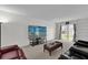 Open living room featuring a large window, built-in shelving and neutral colored carpet at 4804 Laddie Ct, Orlando, FL 32821