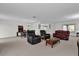 Bright living area leading to a dining area and kitchen, all with neutral carpet flooring at 4804 Laddie Ct, Orlando, FL 32821