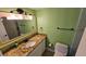 Bathroom featuring green walls, a granite-style countertop, vanity, toilet and chrome fixtures at 4831 Saxon Dr # 1130, New Smyrna Beach, FL 32169