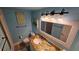 Nautical bathroom with sandy granite countertop, beach-themed decor, and a bright vanity light fixture at 4831 Saxon Dr # 1130, New Smyrna Beach, FL 32169