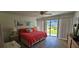 Comfortable bedroom featuring a queen bed and access to a balcony at 4831 Saxon Dr # 1130, New Smyrna Beach, FL 32169