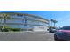 Exterior view of Surfside condos with sign, palm trees, and parking at 4831 Saxon Dr # 1130, New Smyrna Beach, FL 32169