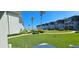 Beautifully landscaped grounds with lush green grass and views of the condo buildings in the distance at 4831 Saxon Dr # 1130, New Smyrna Beach, FL 32169