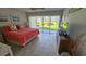 Bright main bedroom with tiled floors, TV, and porch access at 4831 Saxon Dr # 1130, New Smyrna Beach, FL 32169