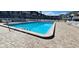 Sparkling community pool with ample lounge chairs and tables offers ocean views at 4831 Saxon Dr # 1130, New Smyrna Beach, FL 32169