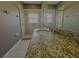 A bright bathroom featuring a large vanity and glass enclosed shower at 5 W Harding St # E, Orlando, FL 32806