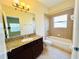 A bathroom featuring a granite vanity top and shower-tub combo at 5 W Harding St # E, Orlando, FL 32806