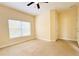 A bright bedroom with a window and ceiling fan at 5 W Harding St # E, Orlando, FL 32806