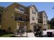 Multi-story townhome featuring private balconies and attached garages, all under clear, sunny skies at 5 W Harding St # E, Orlando, FL 32806