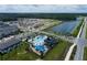 Aerial view showcases a new neighborhood with a pool, playground, and a lake at 5096 Shady Pines Dr, St Cloud, FL 34772