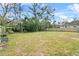 Large, private backyard with mature trees and a wooden fence at 5149 Clarion Oaks Dr, Orlando, FL 32808