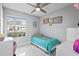 Cozy bedroom with a ceiling fan, window, and playful decor at 5149 Clarion Oaks Dr, Orlando, FL 32808