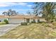 Charming single Gathering home featuring a well manicured lawn and garden with stone features at 5149 Clarion Oaks Dr, Orlando, FL 32808