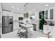 Bright, white kitchen features stainless steel appliances and a stone-accented island with bar seating at 5149 Clarion Oaks Dr, Orlando, FL 32808